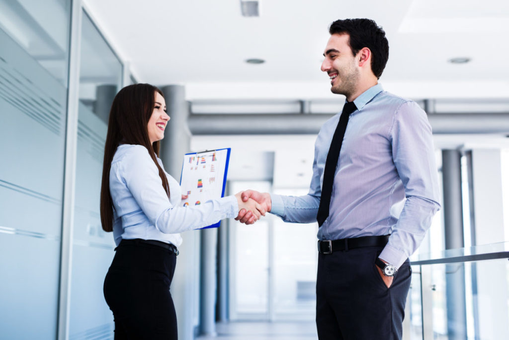 IT specialist shaking hands with a client