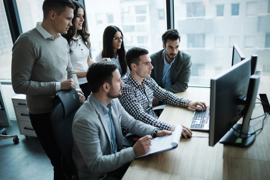 IT team huddled around a computer